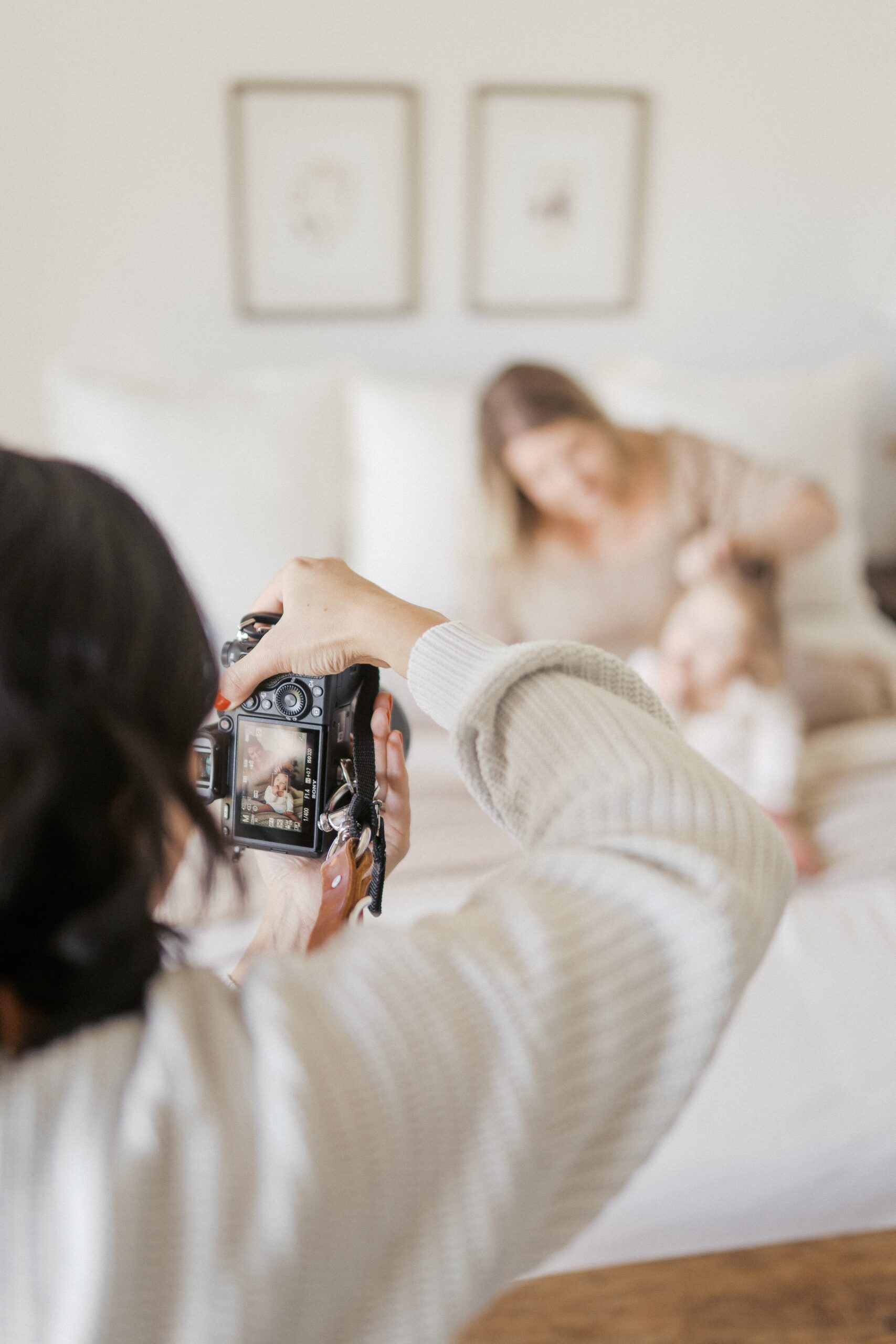 a photographer is taking photos of a mom and her daughter 