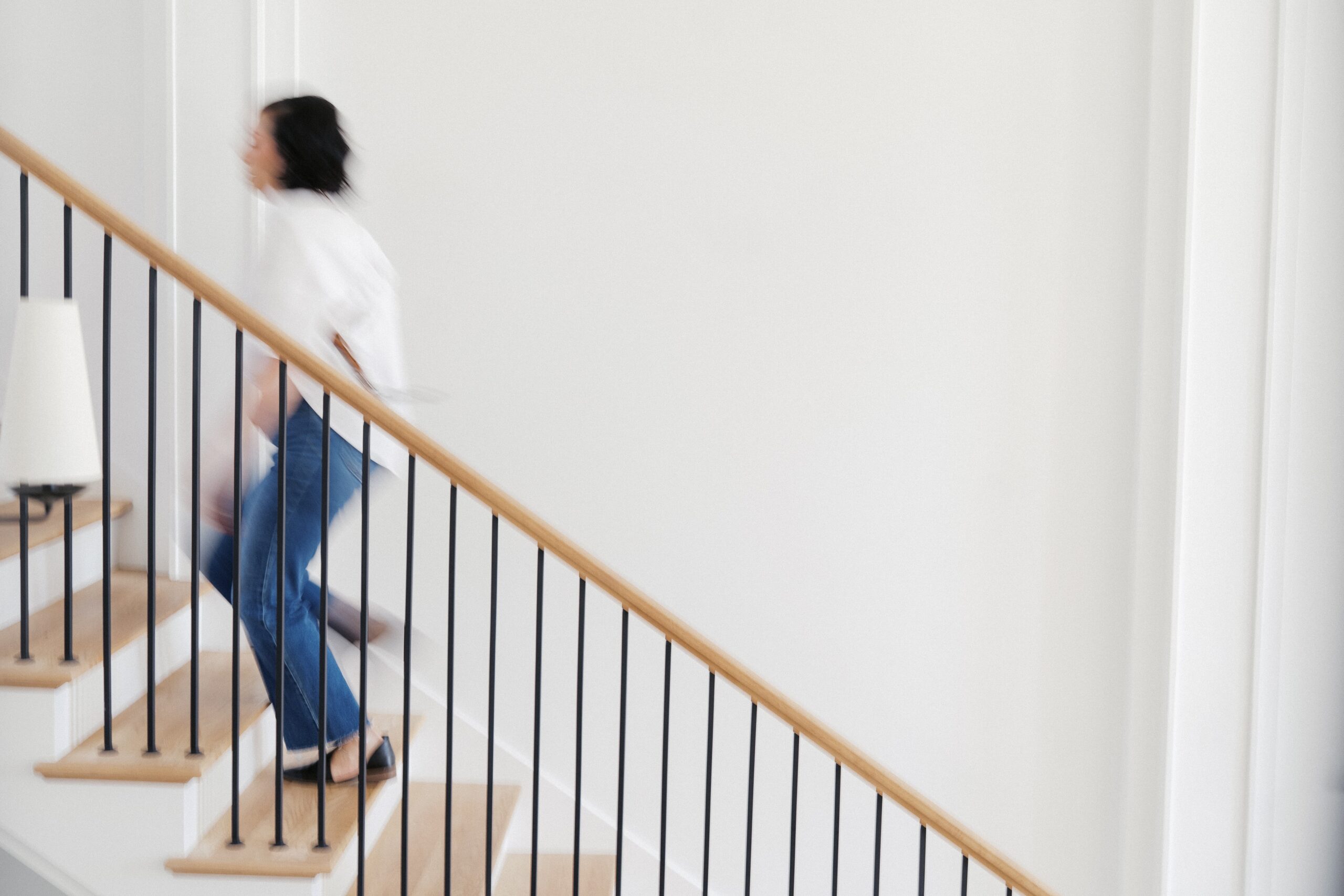 a family photographer is walking up the stairs for their branding photos