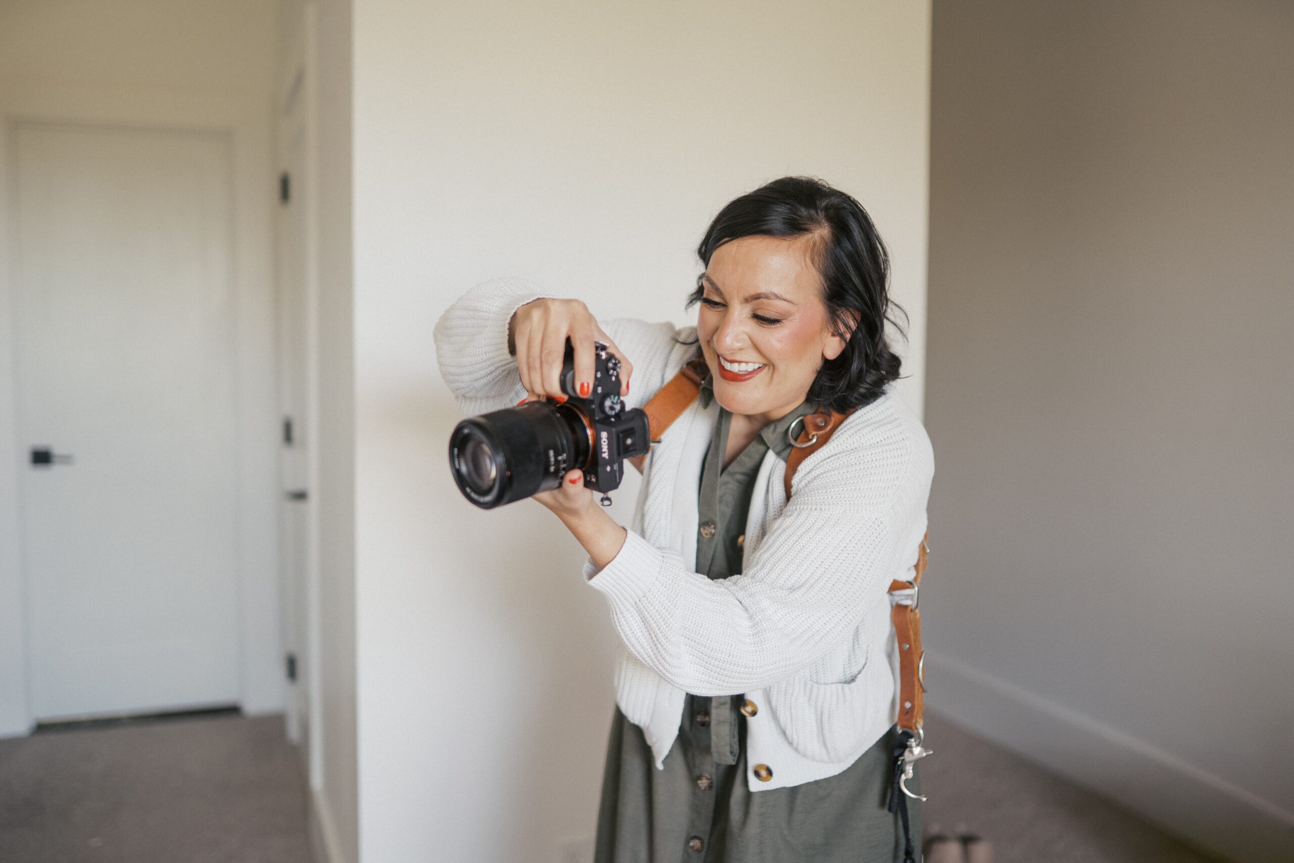 a photo of a woman taking a picture and she is smiling