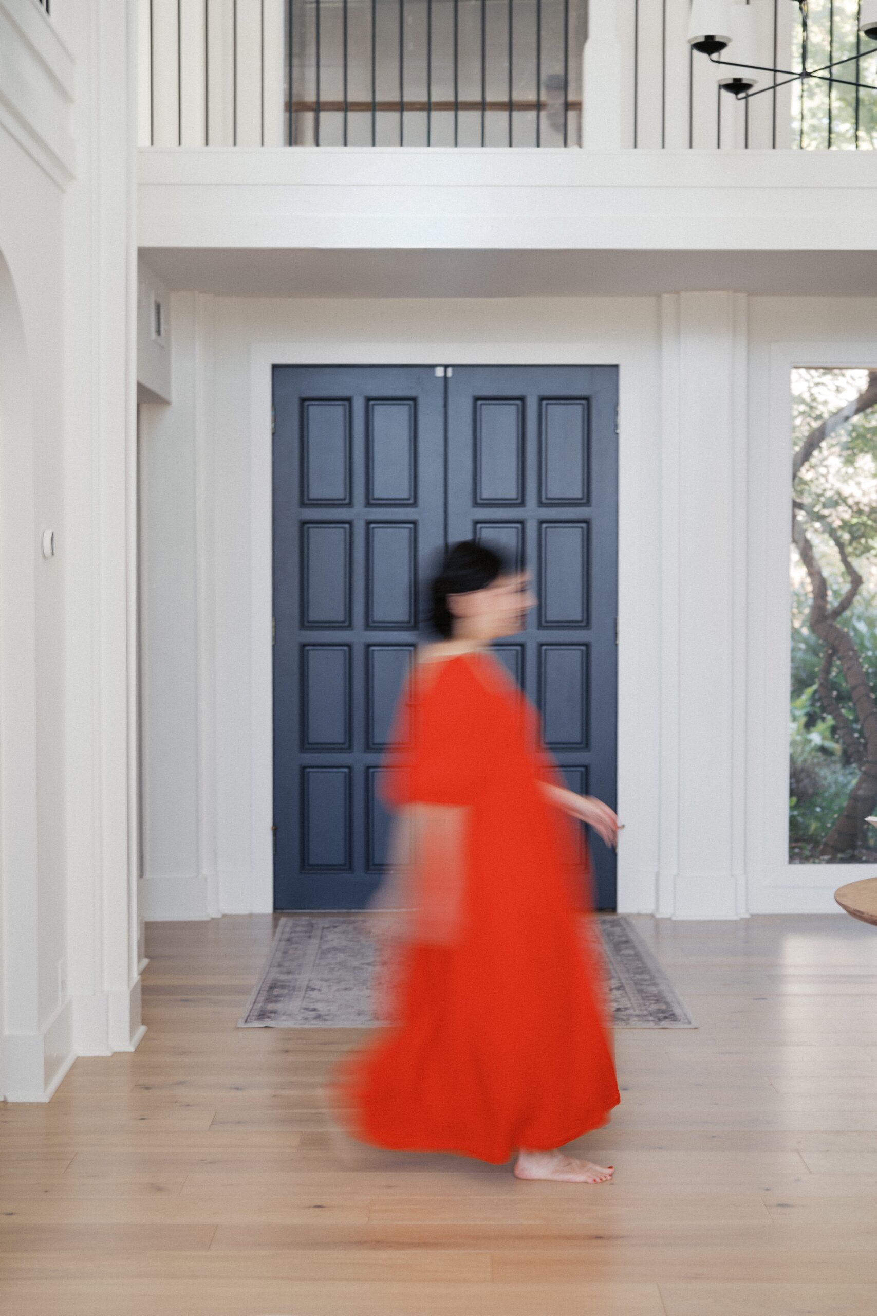 dolly-delong-education-is-wearing-a-red-dress-and-is-walking-very-fast-for-a-blurred-photo-effect